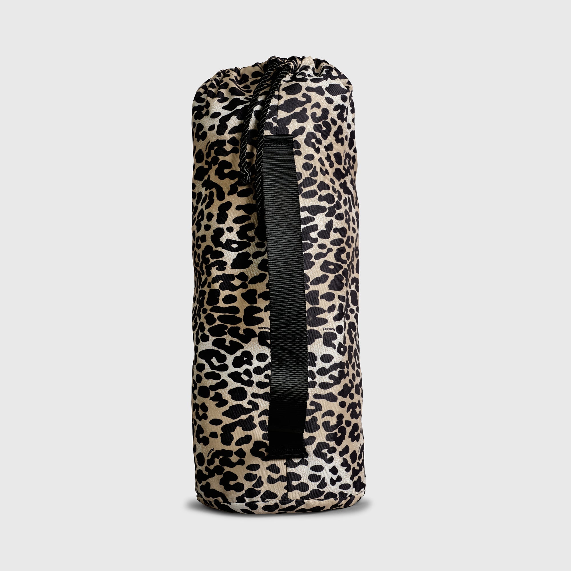 Thoren Eco Playmat in Leopard drawstring bag, side view showing the black carry strap and cord