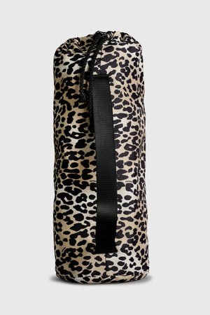 Thoren Eco Playmat in Leopard drawstring bag, side view showing the black carry strap and cord