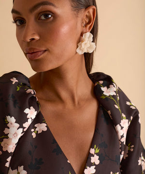 Model wearing floral puff sleeve tiered midi dress in chocolate blossom print.