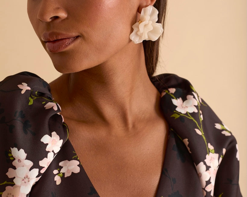 Model wearing floral puff sleeve tiered midi dress in chocolate blossom print.