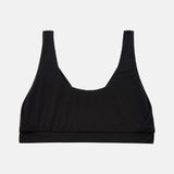 A black scoop-neck sports bra with wide shoulder straps, displayed flat against a light gray background.