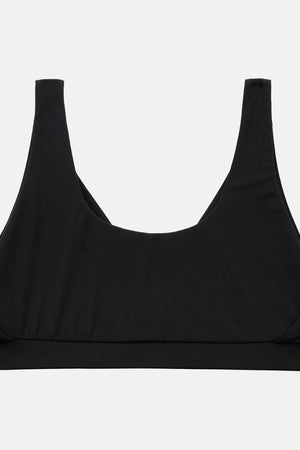 A black scoop-neck sports bra with wide shoulder straps, displayed flat against a light gray background.