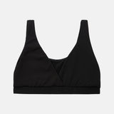 A black wrap-style sports bra or bralette with wide shoulder straps and a wide underband, shown flat against a light gray background.