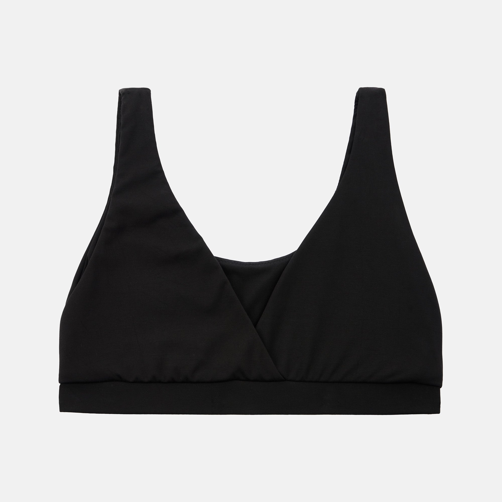 A black wrap-style sports bra or bralette with wide shoulder straps and a wide underband, shown flat against a light gray background.