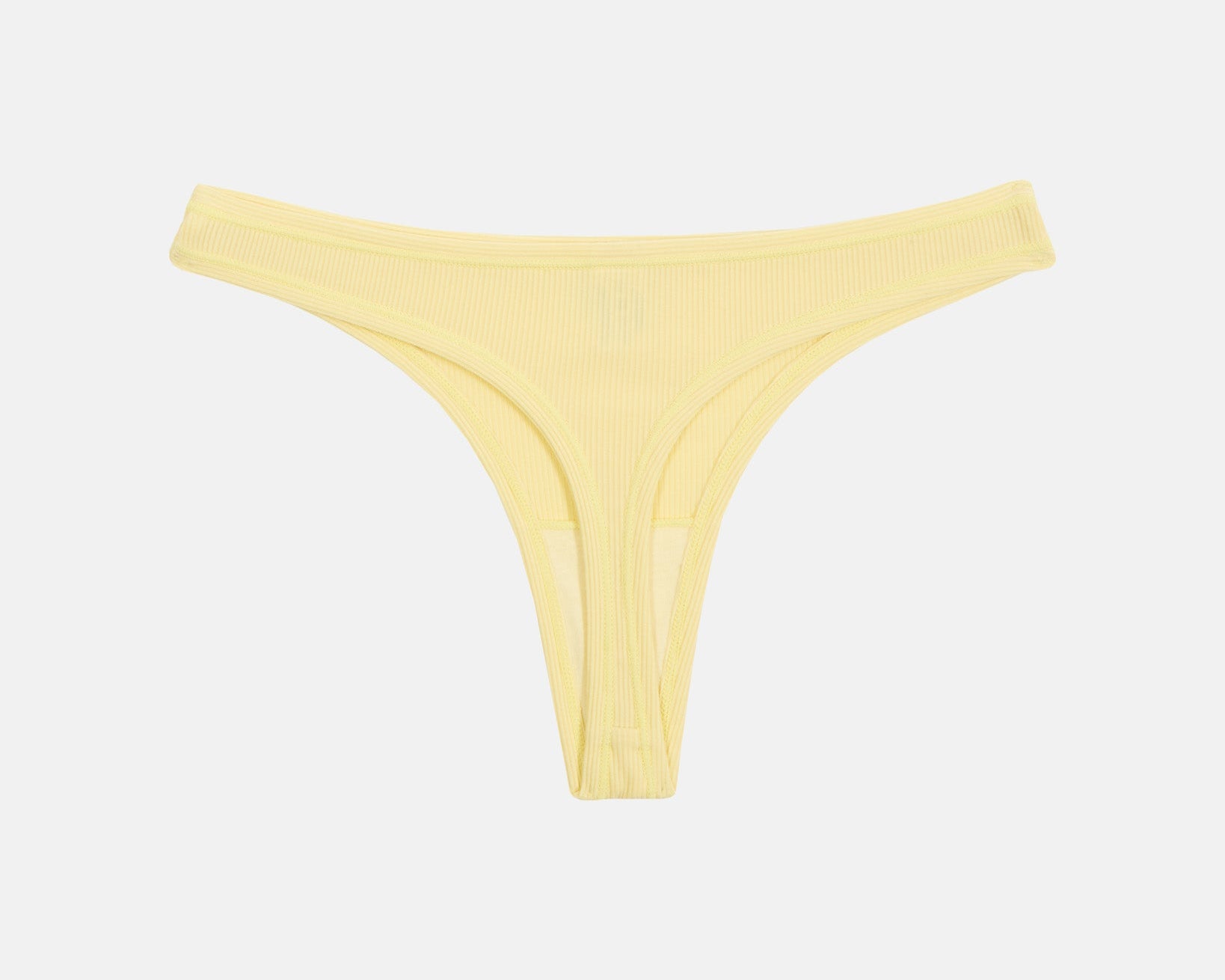 A pale yellow ribbed bikini bottom with a low-rise silhouette, photographed flat against a light gray background.