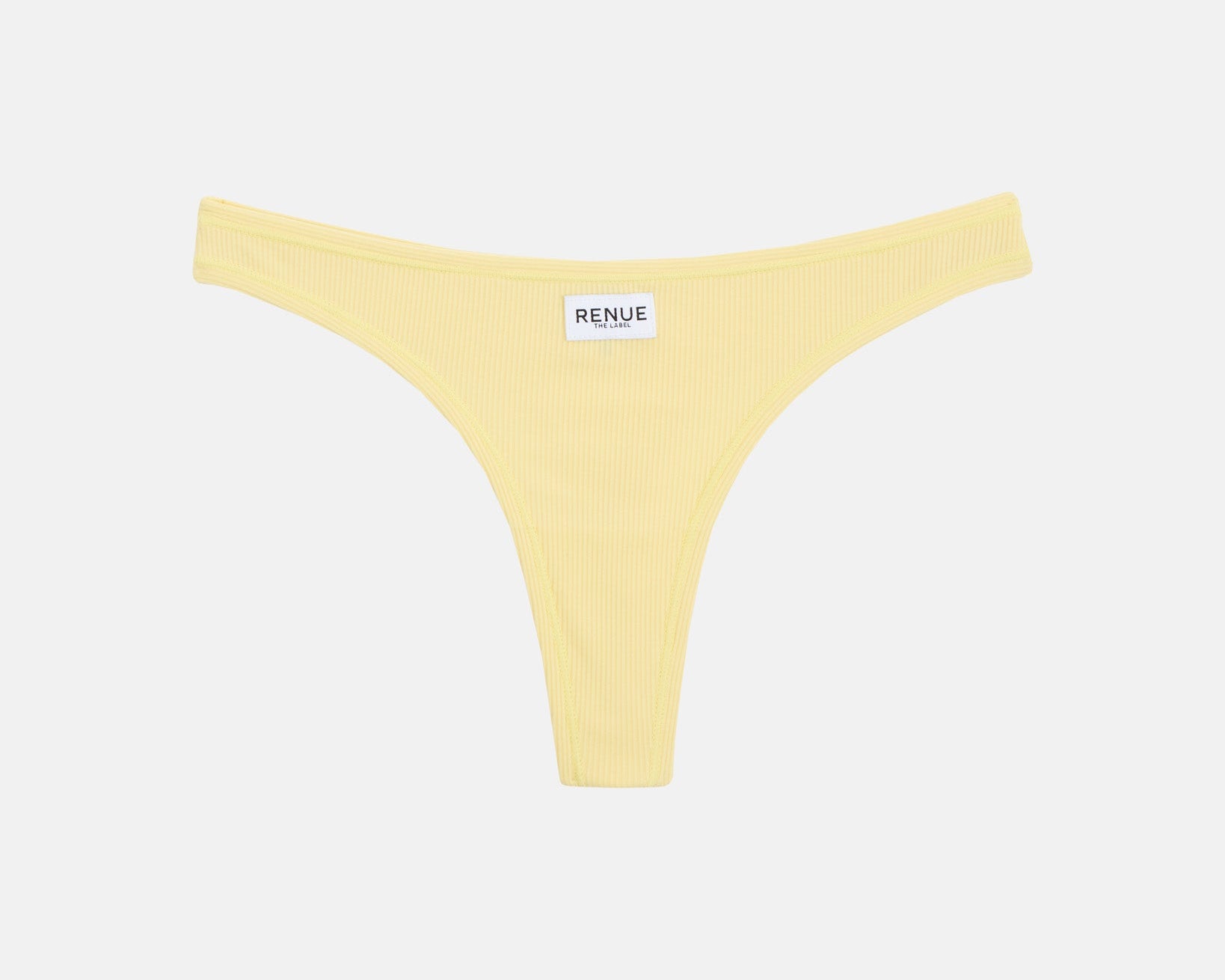 A pale yellow thong-style bikini bottom with a small white brand label reading RENUE at the center front, shown on a plain light gray background.