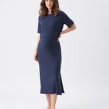 Woman wearing a navy blue dress on a white background