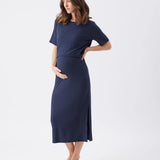 Woman wearing a navy blue dress on a white background
