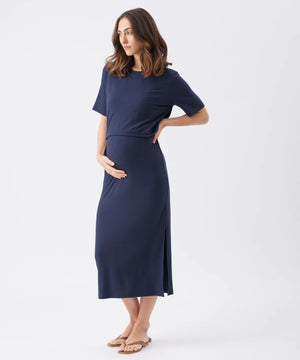 Woman wearing a navy blue dress on a white background