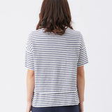 Person wearing a navy and white striped shirt on a plain background