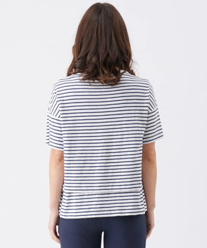 Person wearing a navy and white striped shirt on a plain background