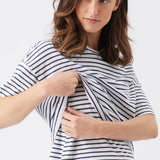 Woman wearing a navy and white striped shirt on a plain background