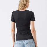 Person wearing a black t-shirt and light blue jeans on a white background