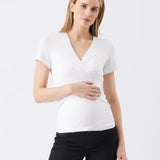 Woman wearing a white short-sleeve top and black pants on a white background