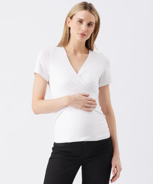 Woman wearing a white short-sleeve top and black pants on a white background