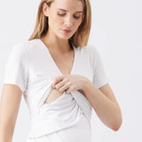 Woman wearing a white dress with a plain background