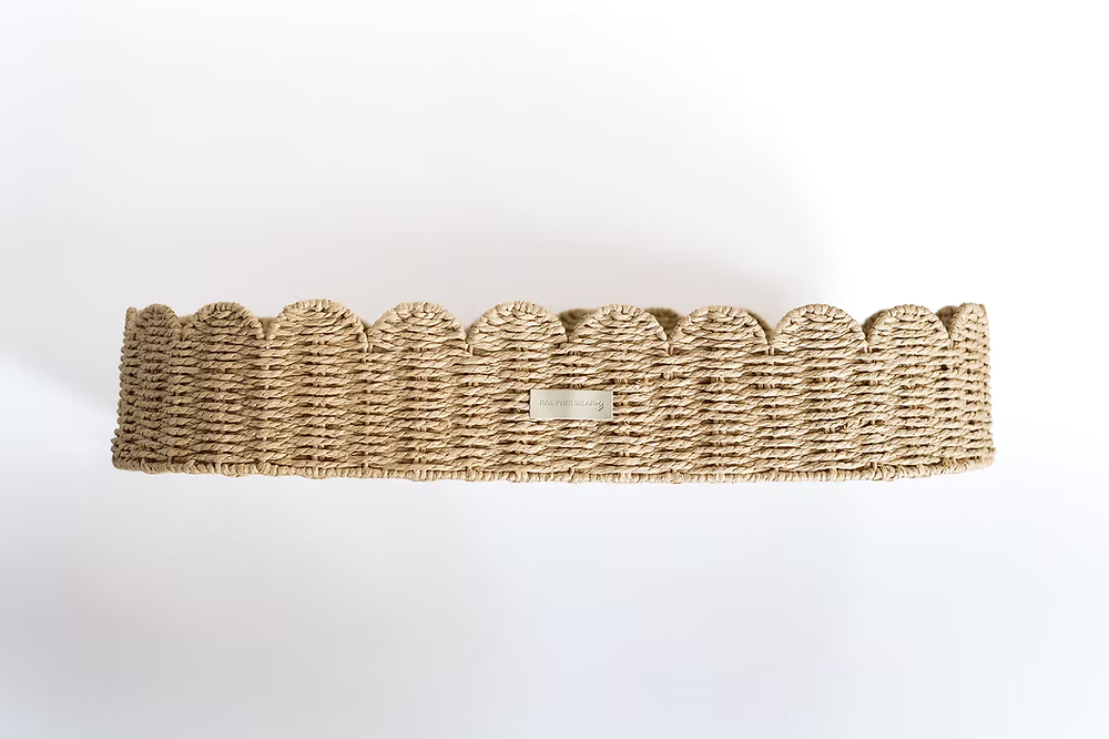Ralphie Bear scallop edge baby changing basket in neutral tones with curved edges and woven texture.