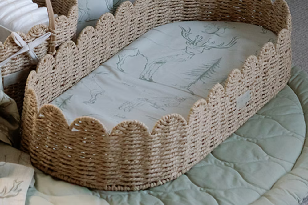 Ralphie Bear scallop edge baby changing basket in neutral tones with curved edges and woven texture.