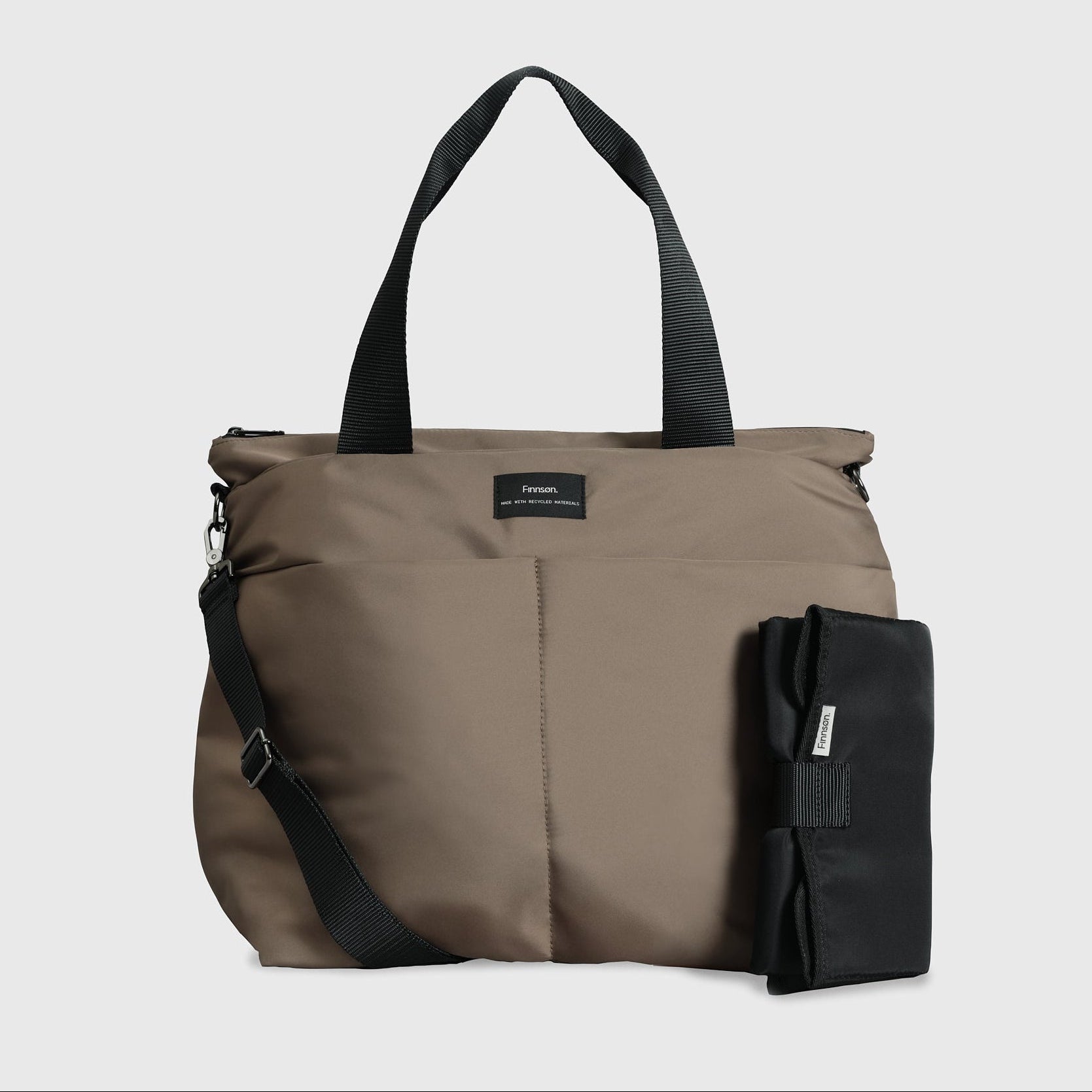 Sigrid Eco Changing Bag in Mocha, front view with top handles, crossbody strap and black changing mat beside it