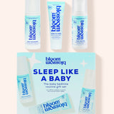 Blossom Sleep Like A Baby routine gift set featuring a light blue and white product box with three matching baby care items displayed above it on a pale peach background.