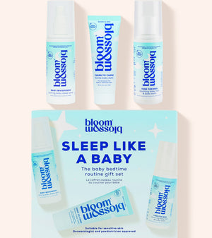 Blossom Sleep Like A Baby routine gift set featuring a light blue and white product box with three matching baby care items displayed above it on a pale peach background.