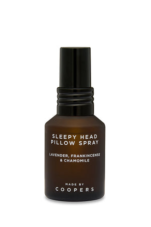 Sleepy Head Pillow Spray brown glass bottle with black pump, front view on a white background