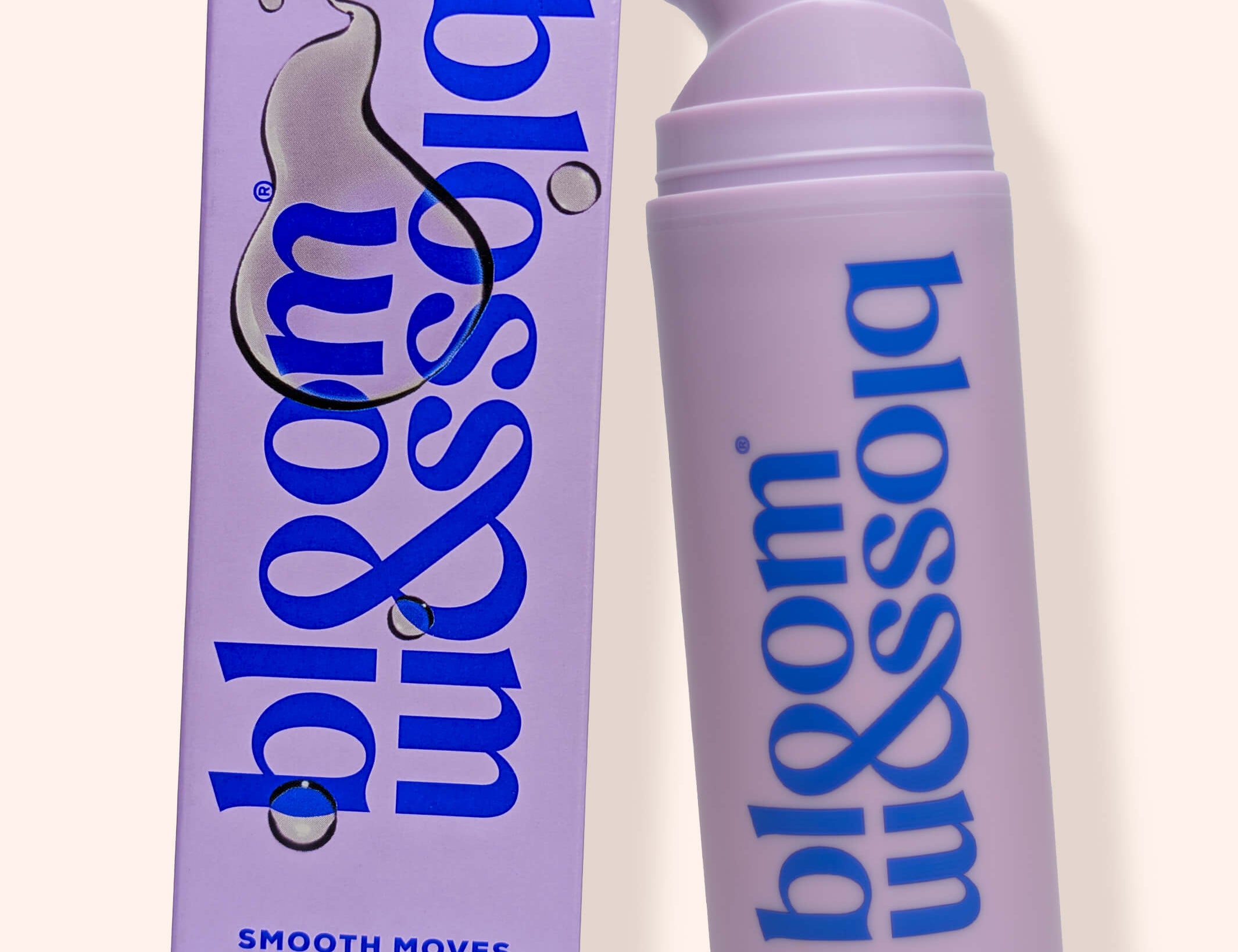 A lavender pump bottle and matching rectangular box for bloom & soia Smooth Moves Stretch mark oil, shown on a warm off-white background.