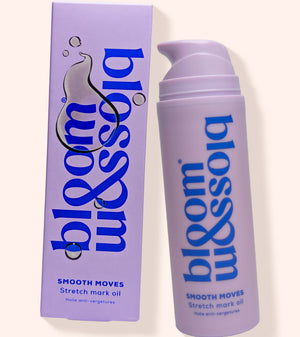 A lavender pump bottle and matching rectangular box for bloom & soia Smooth Moves Stretch mark oil, shown on a warm off-white background.