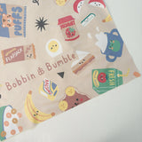 Splash Mat Snack Time, close-up of a corner showing the snack characters pattern and Bobbin and Bumble name on beige