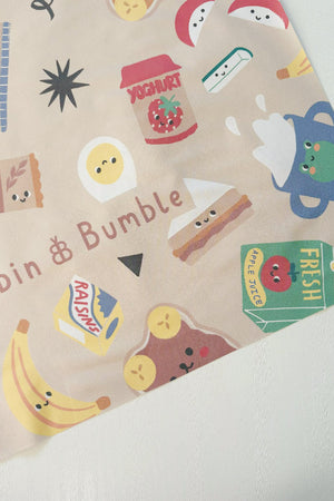 Splash Mat Snack Time, close-up of a corner showing the snack characters pattern and Bobbin and Bumble name on beige