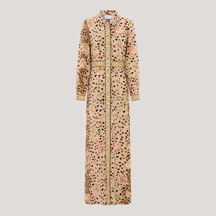 A long-sleeved maxi shirt dress with a mixed print of leopard spots, pink roses, and green leaves on a beige base, featuring a gold patterned trim down the front and cuffs.