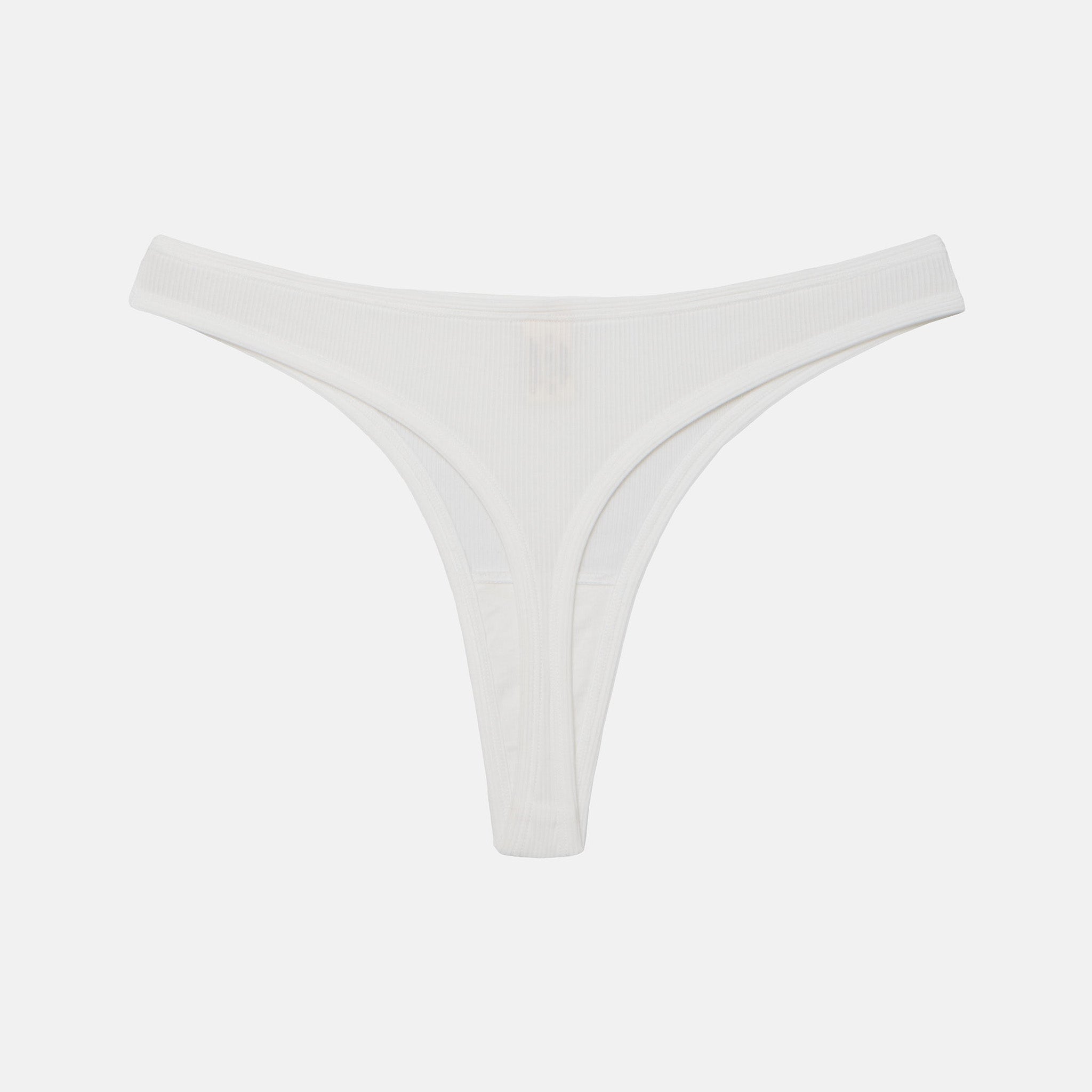 White ribbed thong underwear with a small tonal embroidered logo at the center front, displayed flat against a light gray background.