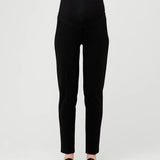 Black pants worn by a person on a white background
