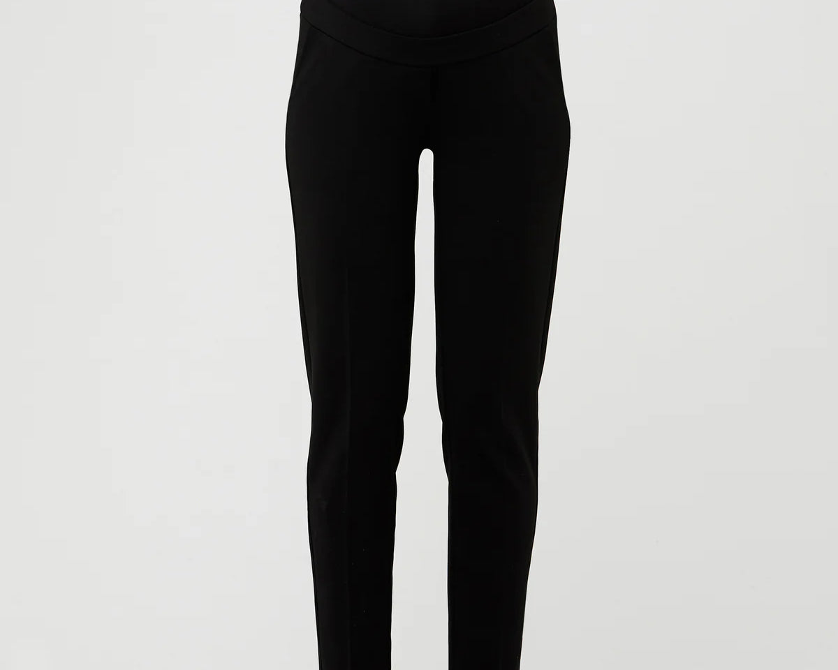 Black pants worn by a person on a white background