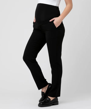 Person wearing black pants on a white background