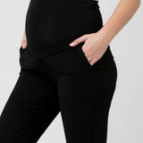 Black pants worn by a person on a white background