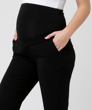 Black pants worn by a person on a white background