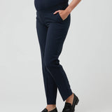 Navy blue maternity pants worn by a person on a light gray background