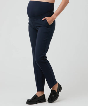 Navy blue maternity pants worn by a person on a light gray background