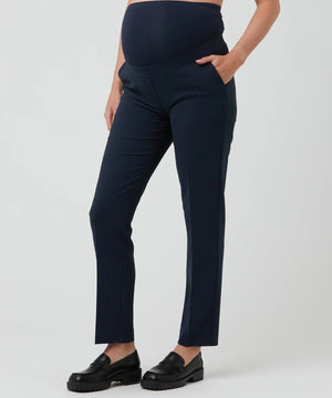 Navy blue maternity pants worn by a person on a white background