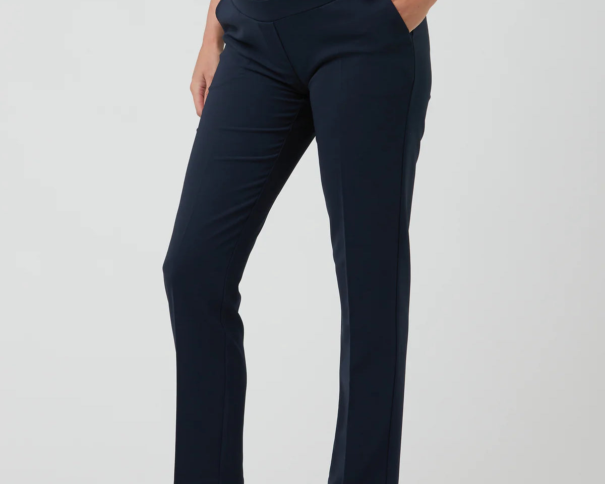 Navy blue maternity pants worn by a person on a white background