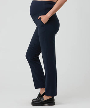 Navy blue pants worn by a person on a light gray background