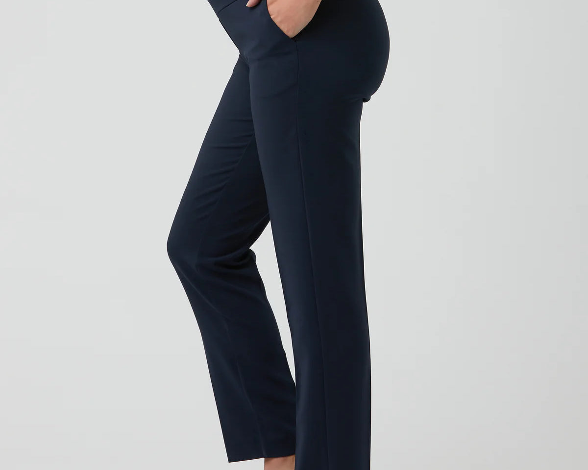Navy blue pants worn by a person on a light gray background