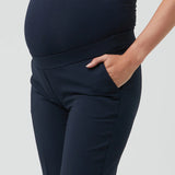 Navy blue maternity pants worn by a person on a light gray background