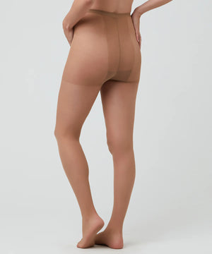 Beige sheer stockings worn by a model on a white background