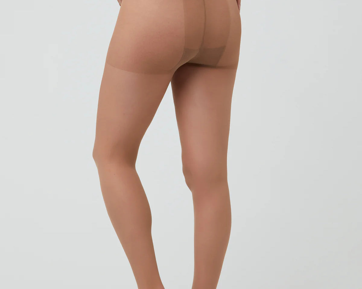 Beige sheer stockings worn by a model on a white background