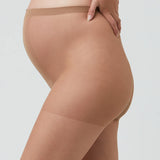 Beige sheer stockings worn by a person on a light gray background