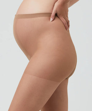 Beige sheer stockings worn by a person on a light gray background