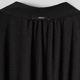 Black garment with 'AWAN' label on a light gray background