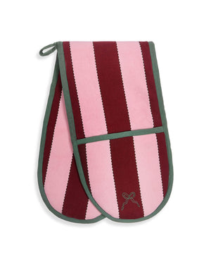 A pair of oven mitts featuring vertical stripes of light pink and deep burgundy, finished with sage green trim and a small embroidered bow on the front pocket.
